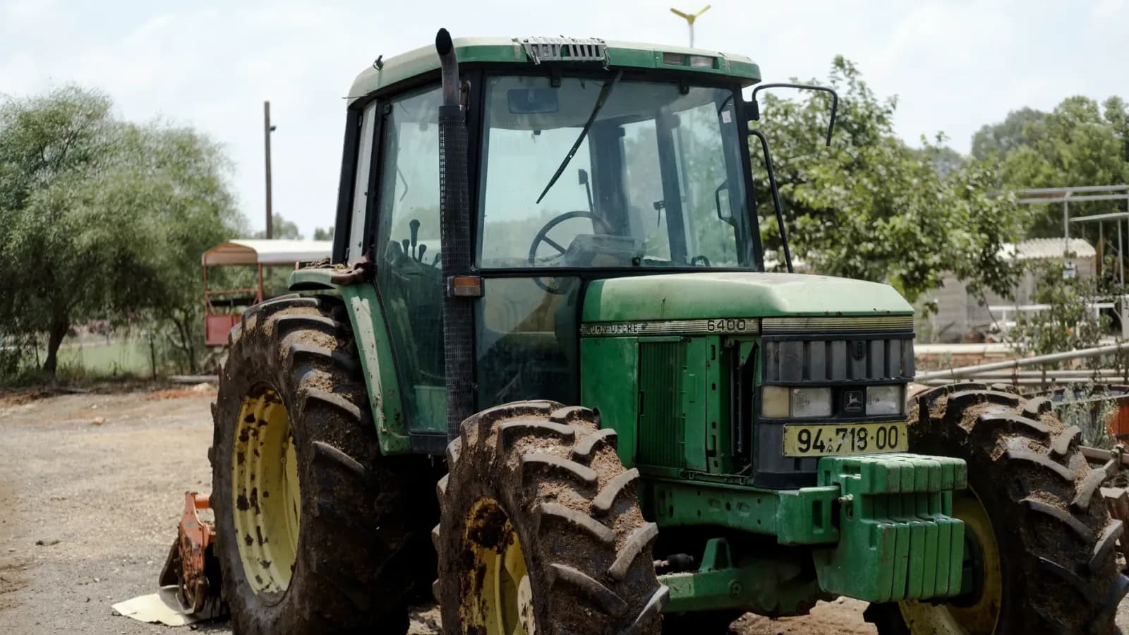 A tractor and combine harvester on rural road